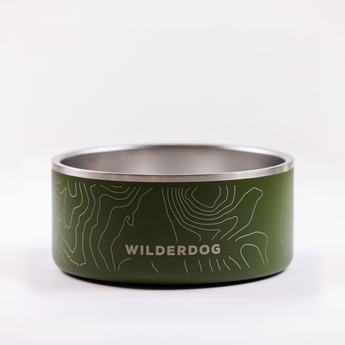 A green "Stainless Steel Dog Bowl" with "WILDERDOG" printed on it in white uppercase letters. The BPA-free bowl showcases a topographic map design in white lines around the exterior and features a durable stainless steel interior. It is set against a plain white background.