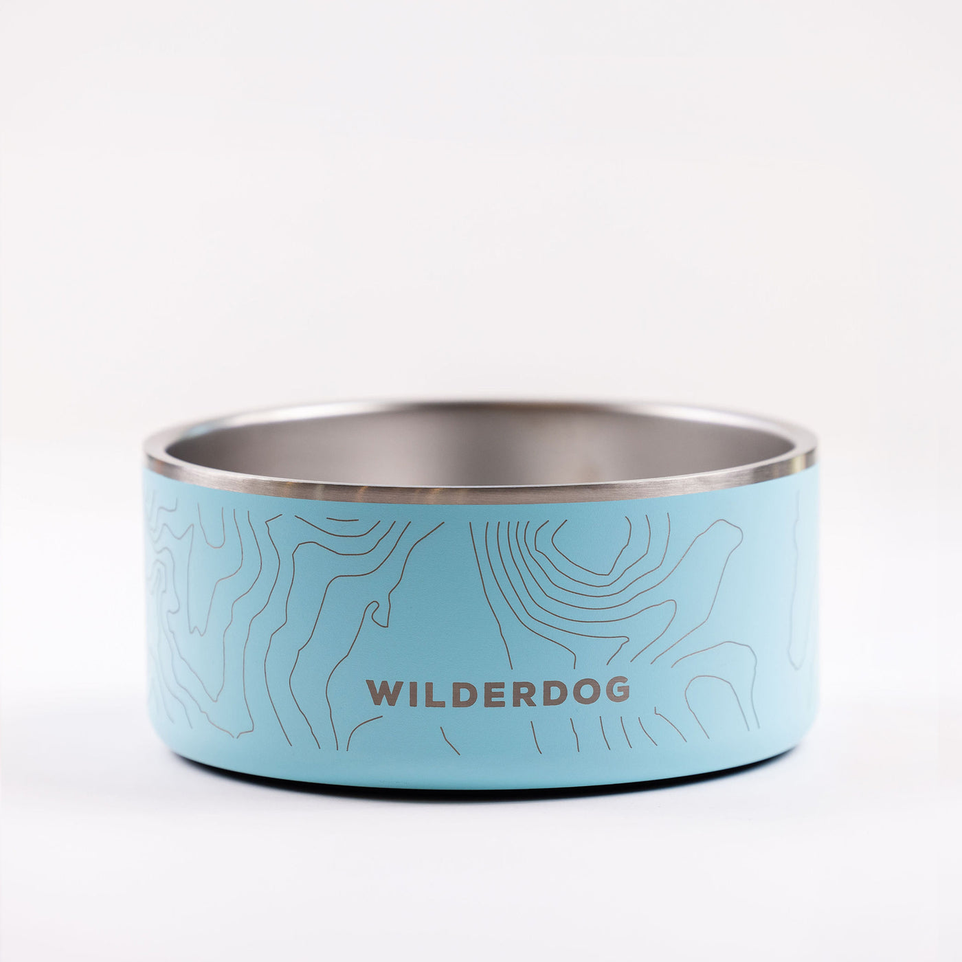 A light blue, BPA-free Stainless Steel Dog Bowl featuring a stainless steel interior. The bowl boasts a subtle contour line pattern and the word "WILDERDOG" printed prominently in uppercase letters in the center. The background is white.