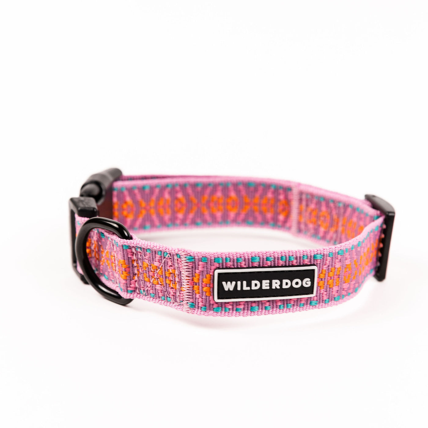 Introducing the Lilac Ultralight Collar, a vibrant canine accessory from our Ultralight Collection. This collar features an eye-catching pink, orange, and blue pattern on robust nylon webbing. It includes a durable black plastic buckle and a metal D-ring for secure leash attachment. Proudly displaying the "WILDERDOG" label on its fabric, this collar is showcased against a minimalist white background.