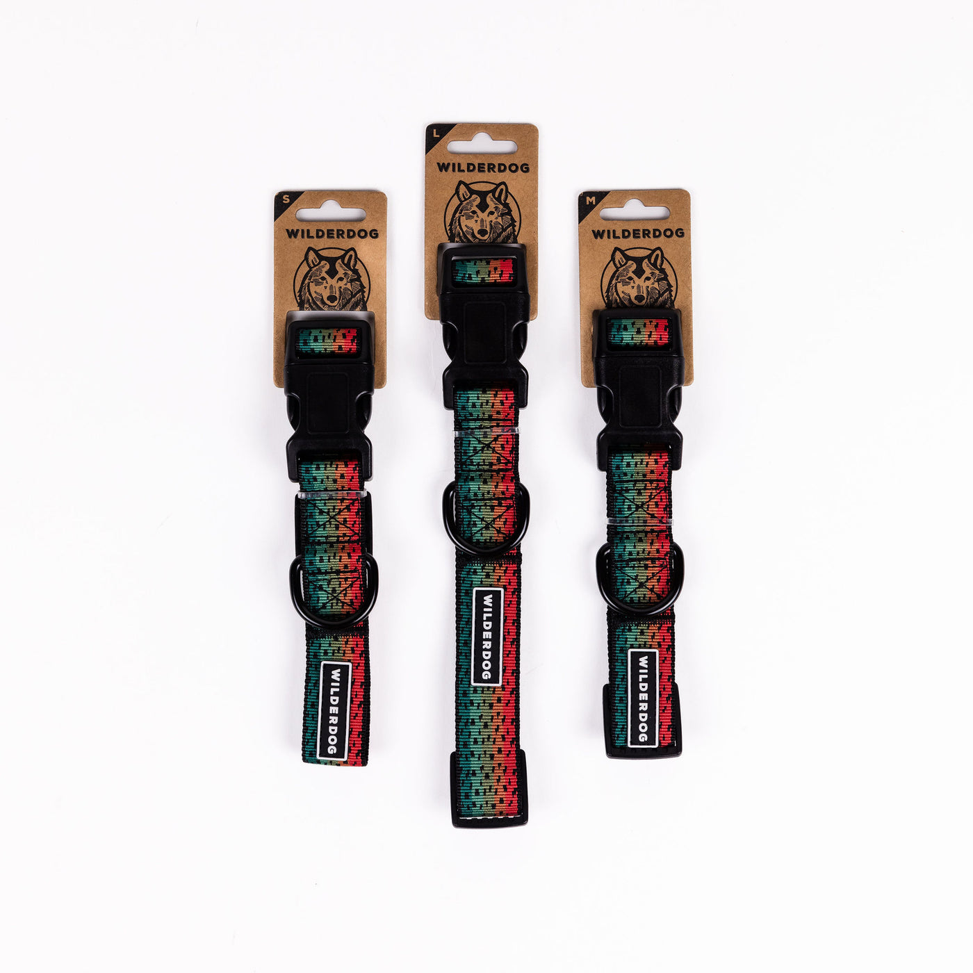 Three Trout Ultralight Collars are displayed vertically against a plain white background. The collars, part of the Wilderdog Ultralight Collection, feature a red and green pixelated pattern and have heavy-duty plastic clips. The packaging with the Wilderdog logo and product information is visible at the top of each collar.