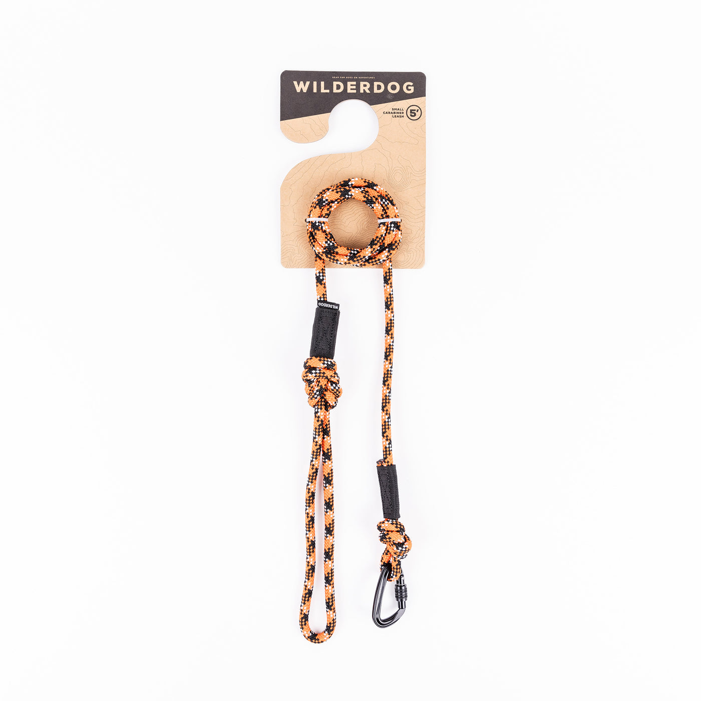 Leash by Wilderdog on white background: the Wildcat Small Carabiner Leash is made from orange and black braided rock climbing rope, featuring a metal clip at one end and a handle at the other. The packaging prominently displays the brand name at the top.